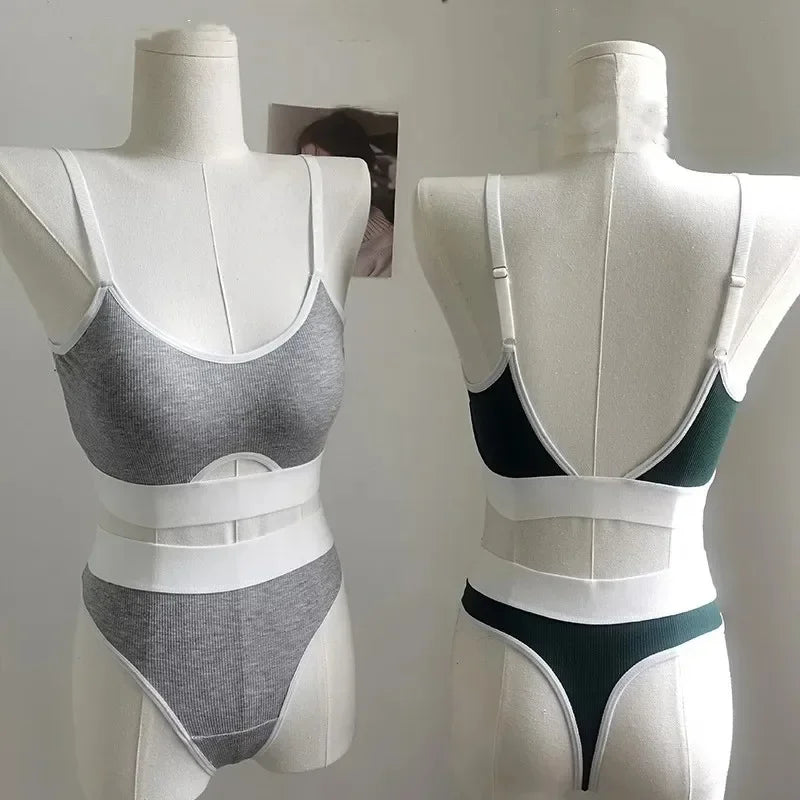 Gray and black bra and underwear set on mannequins against a plain background