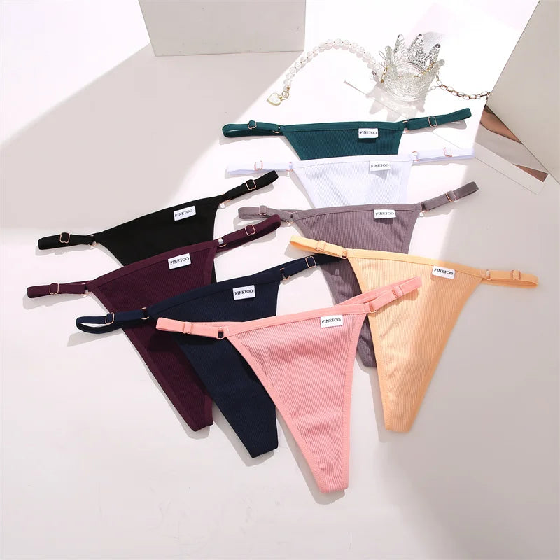 Collection of colorful thongs on a light gray surface