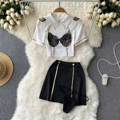 White shirt with gold accents and black lace bralette on a white fur rug.