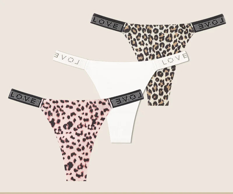 Leopard print and white panties with 'LOVE' waistband on beige background