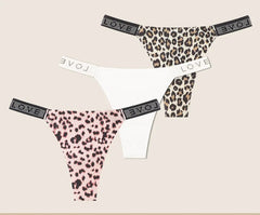 Leopard print and white panties with 'LOVE' waistband on beige background