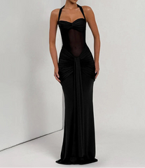 Woman wearing a black evening gown against a white background