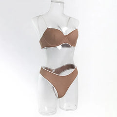 Brown ribbed bra and panties set on a clear mannequin against a white background
