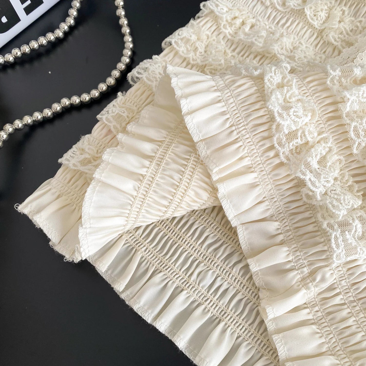 Close-up of beige lace fabric with a black background