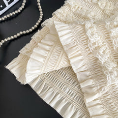 Close-up of beige lace fabric with a black background