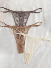 Set of lace lingerie in brown and beige on a white background