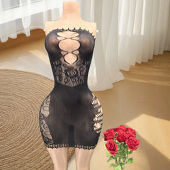 Black lace body stocking on a mannequin with red roses in a room.