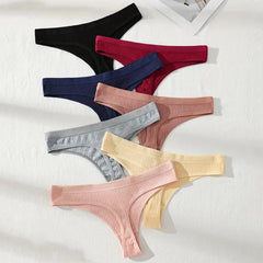 Set of colorful ribbed thongs on a white background