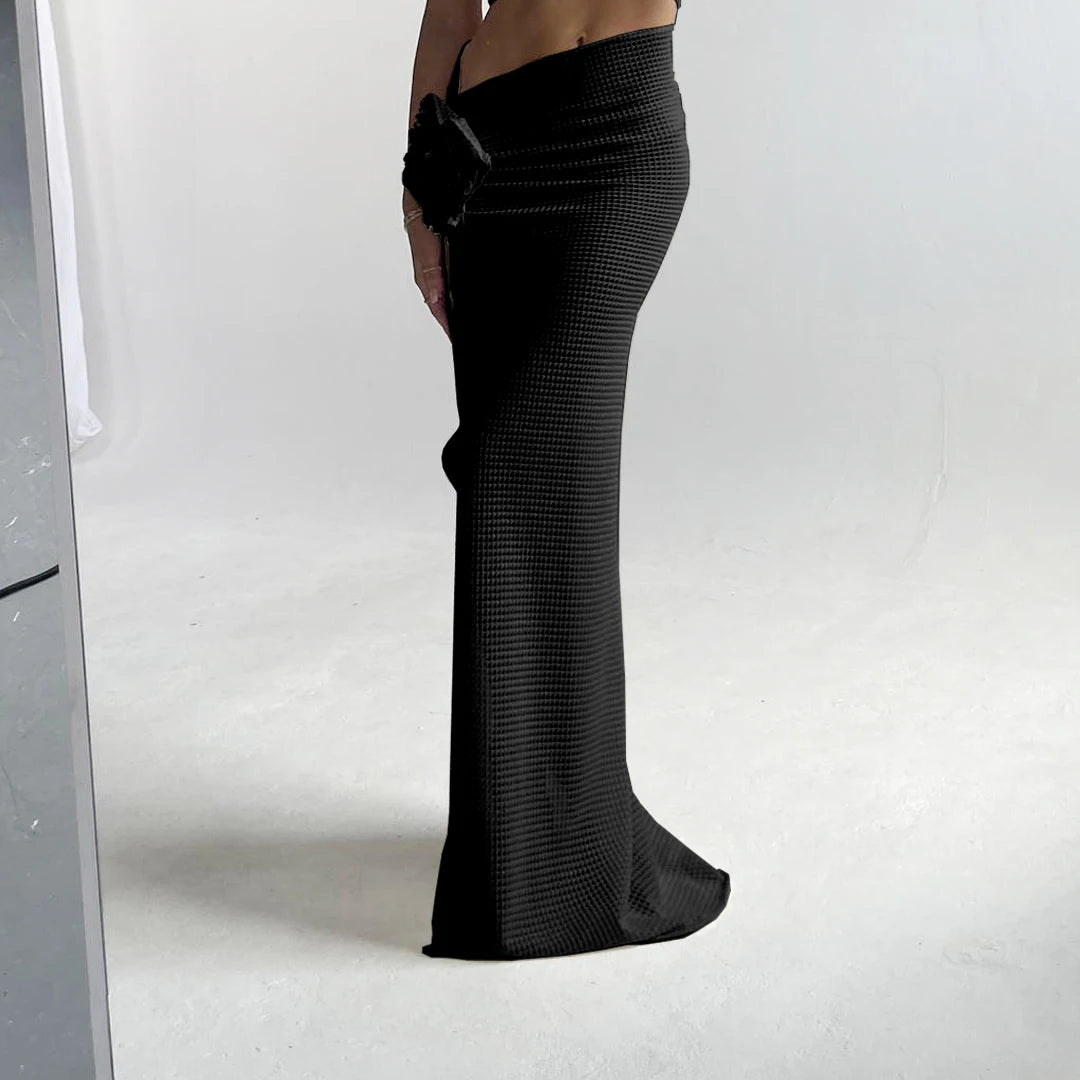 Black textured pants worn by a person on a white background