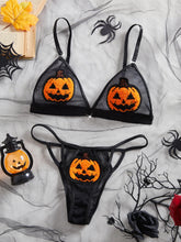 Halloween-themed lingerie set with pumpkin designs on a spider web background.