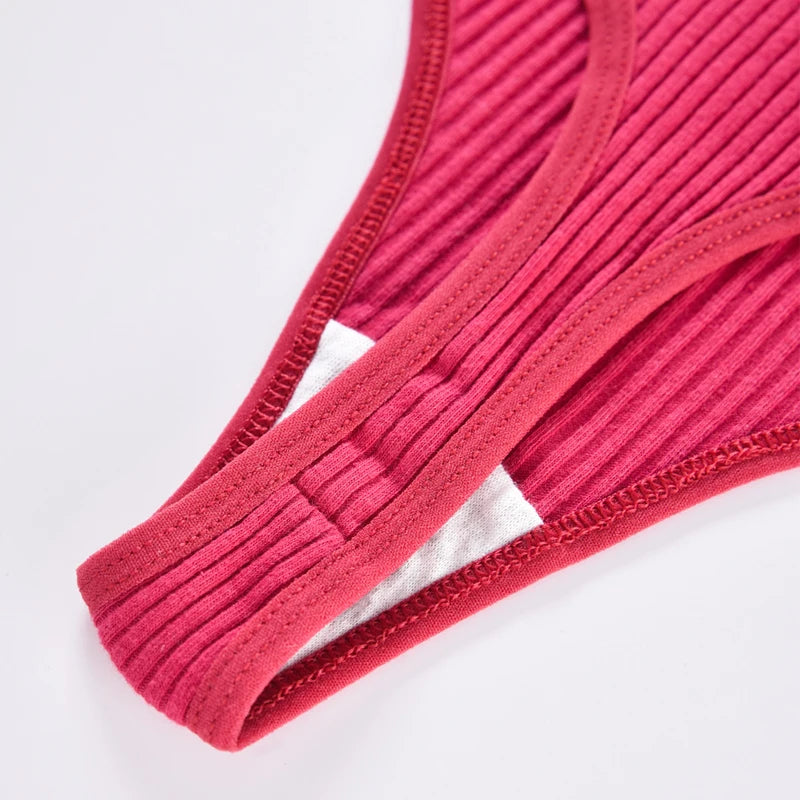 Close-up of red ribbed thong fabric and stitched gusset edges