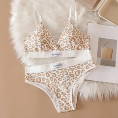 Leopard print bra and panties set on a fur surface with a magazine in the background.