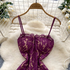 Purple lace bra on a wooden hanger against a white fur background