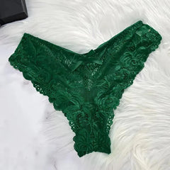 Green lace lingerie on a white textured surface