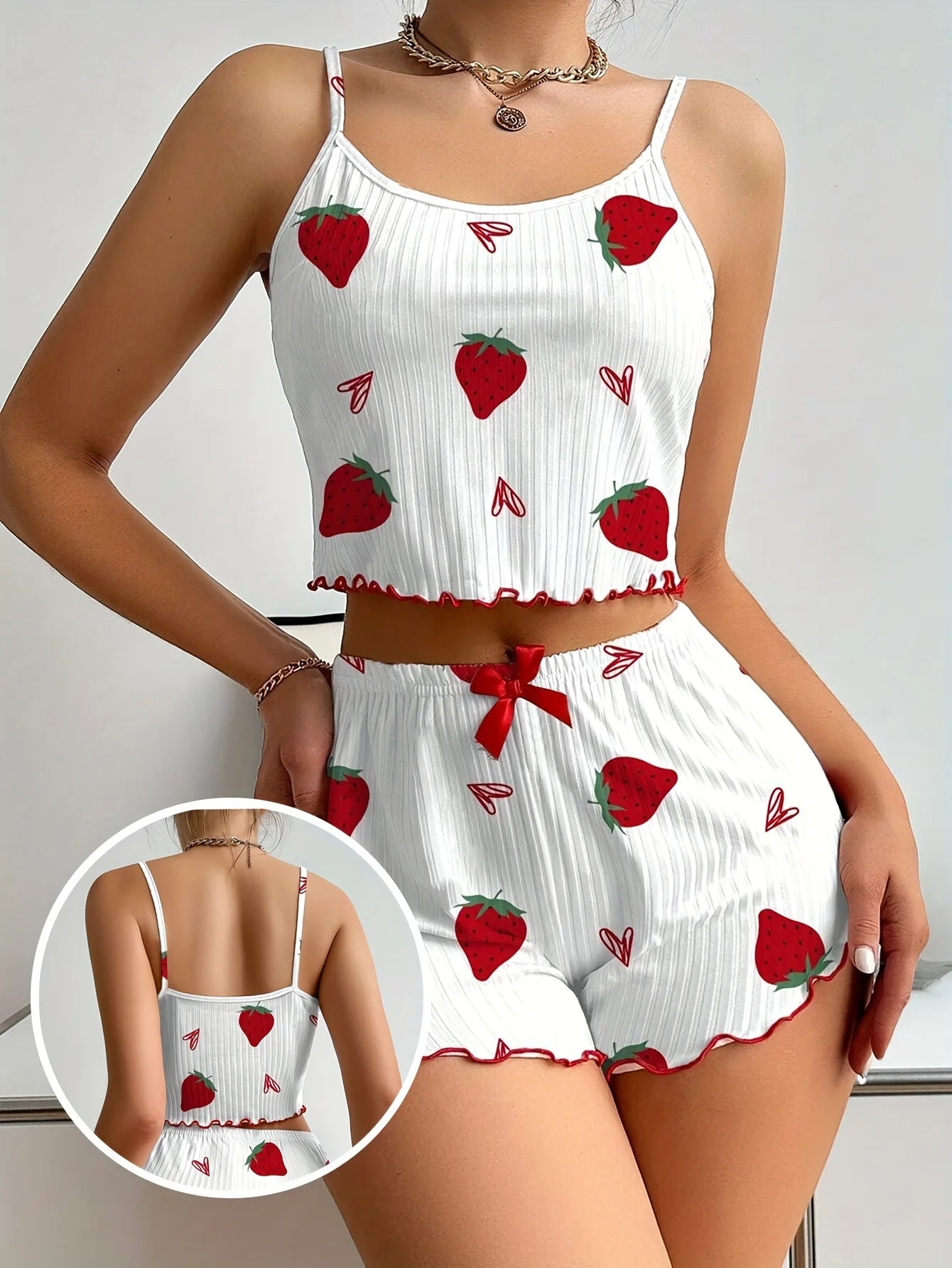 White crop top and shorts set with red strawberry pattern on a plain background