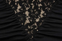Close-up of black lace fabric with a ruched texture