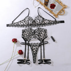 Leopard print lingerie set with roses and a mirror on a white background