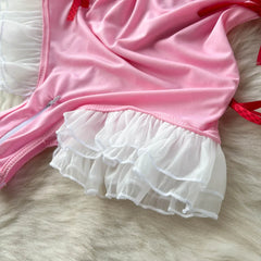 Pink and white ruffled outfit on a fur surface