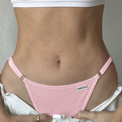 Person wearing a pink thong with 'FIRETOO' branding against a neutral background