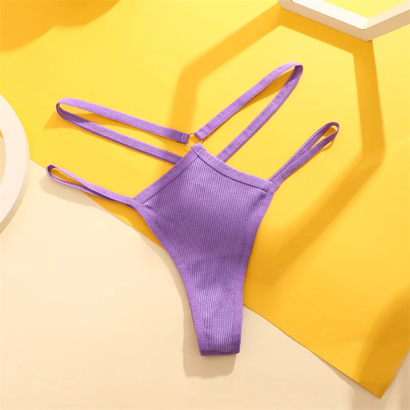 Purple bikini bottom on a yellow and beige geometric background