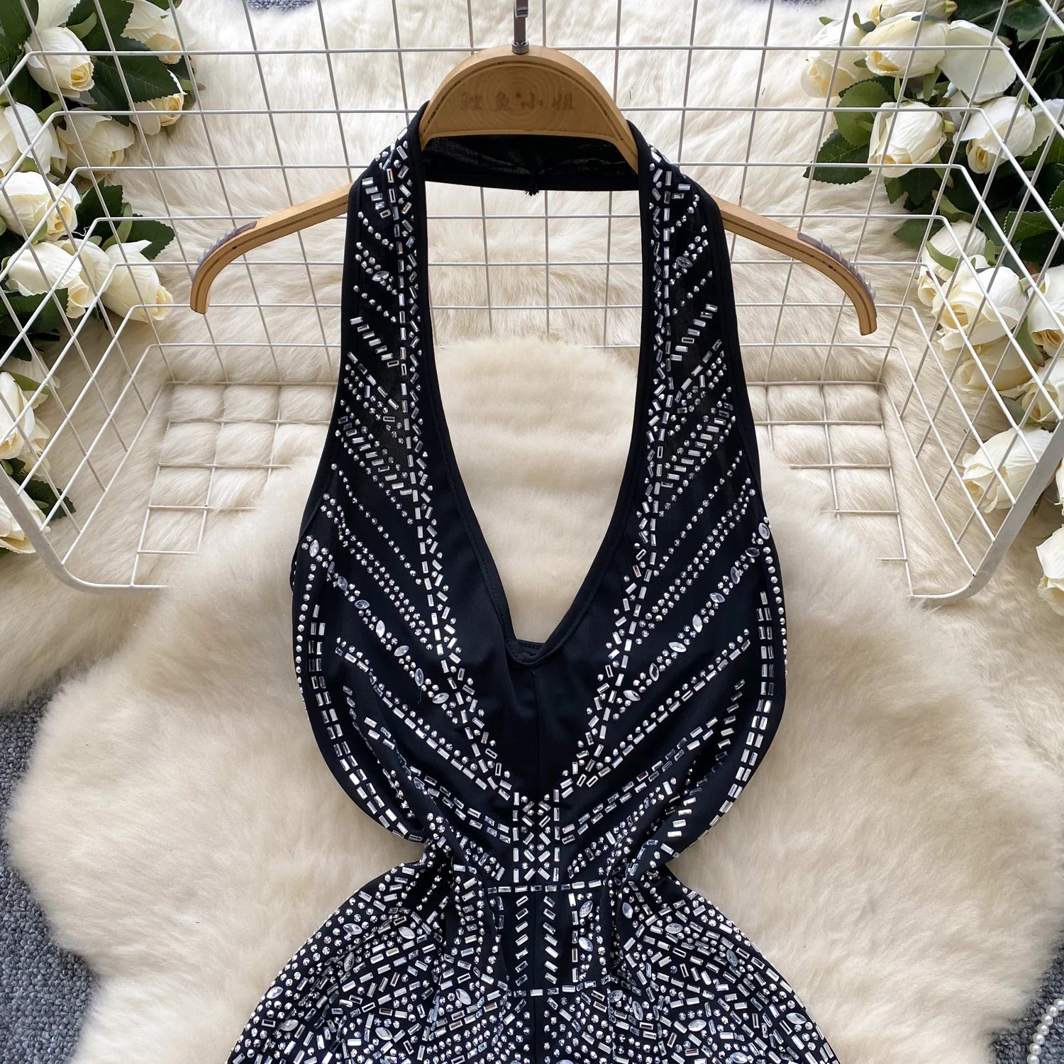 Black and white patterned dress on a hanger with a soft white background