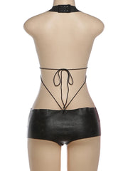 Black satin lingerie set on a mannequin against a white background