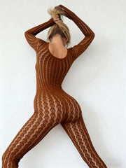 Person wearing a brown patterned bodysuit against a white background