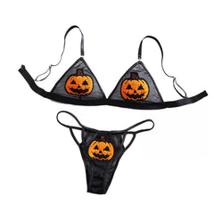Black Halloween-themed bikini set with jack-o'-lantern designs on a white background