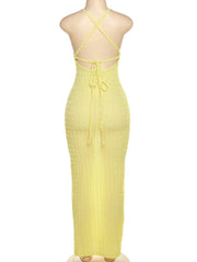 Yellow dress with criss-cross straps on a mannequin against a white background, brand 'kliou' visible.