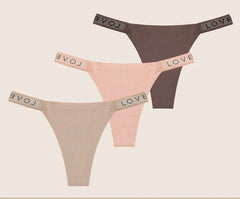 Two pairs of women's panties with rhinestone details on a beige background.