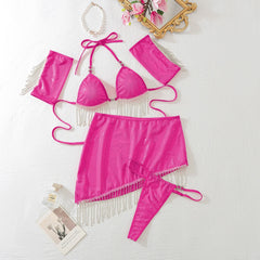 Pink bikini set with fringe details on a white surface.