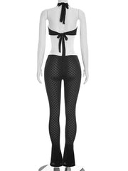 Mannequin wearing a black and white outfit with a bow detail on a white background