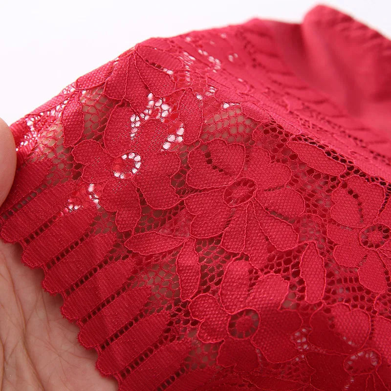 Close-up of red floral lace fabric held by a hand