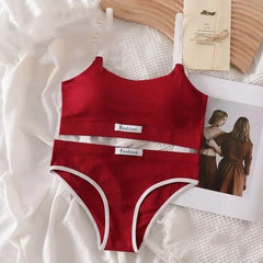 Red swimsuit with white trim on a textured surface