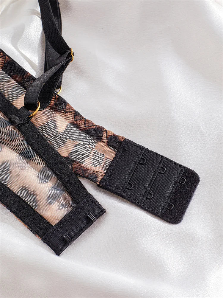 Close-up of a black lace bra strap on a white background