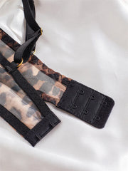 Close-up of a black lace bra strap on a white background