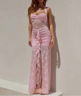Woman wearing a pink lace dress against a plain background