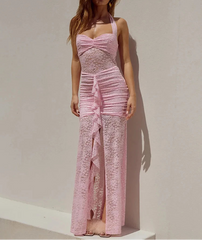 Woman wearing a pink lace dress against a plain background