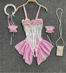 Pink lingerie set with accessories on a gray surface