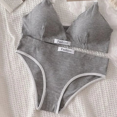 Gray women's underwear set with 'Fashion' labels on a textured white surface