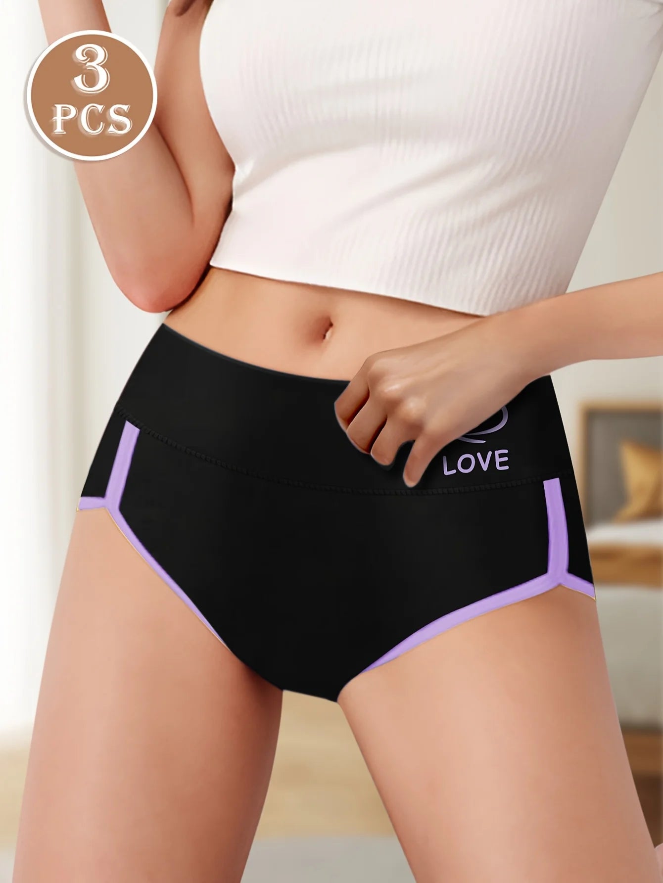 Black underwear with purple accents worn by a person, with 'LOVE' text on a neutral background.