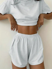 Person wearing a matching striped crop top and shorts set on a plain background