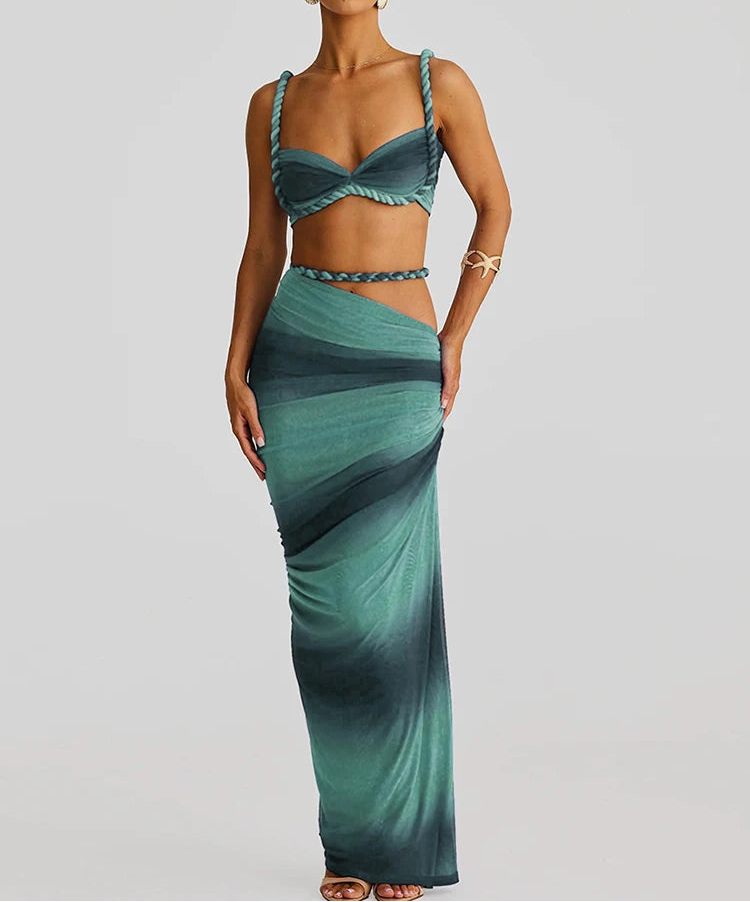 Woman wearing a green dress with a gradient effect on a plain background