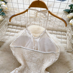 White textured top on a wooden hanger against a white grid background