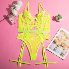 Neon yellow lace lingerie set on a pink background with decorative elements.