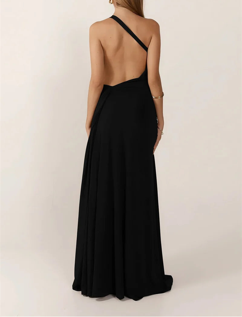 Woman wearing a black one-shoulder dress with a plain background