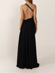 Woman wearing a black one-shoulder dress with a plain background