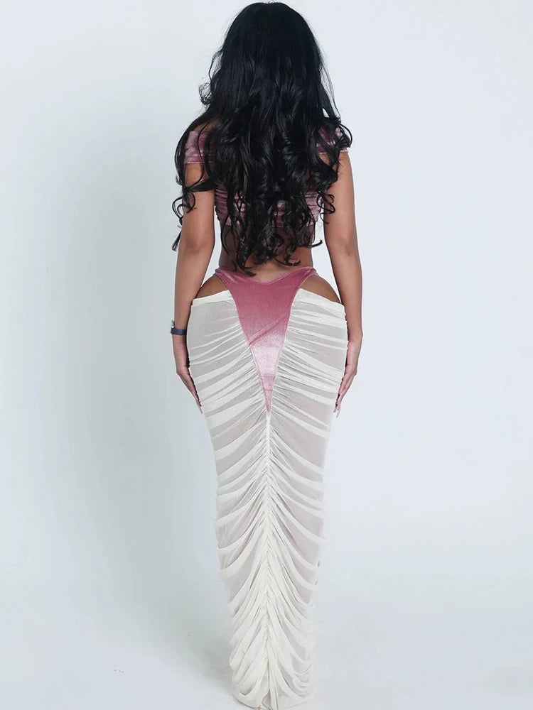 Woman wearing a pink top and white ruffled skirt on a white background