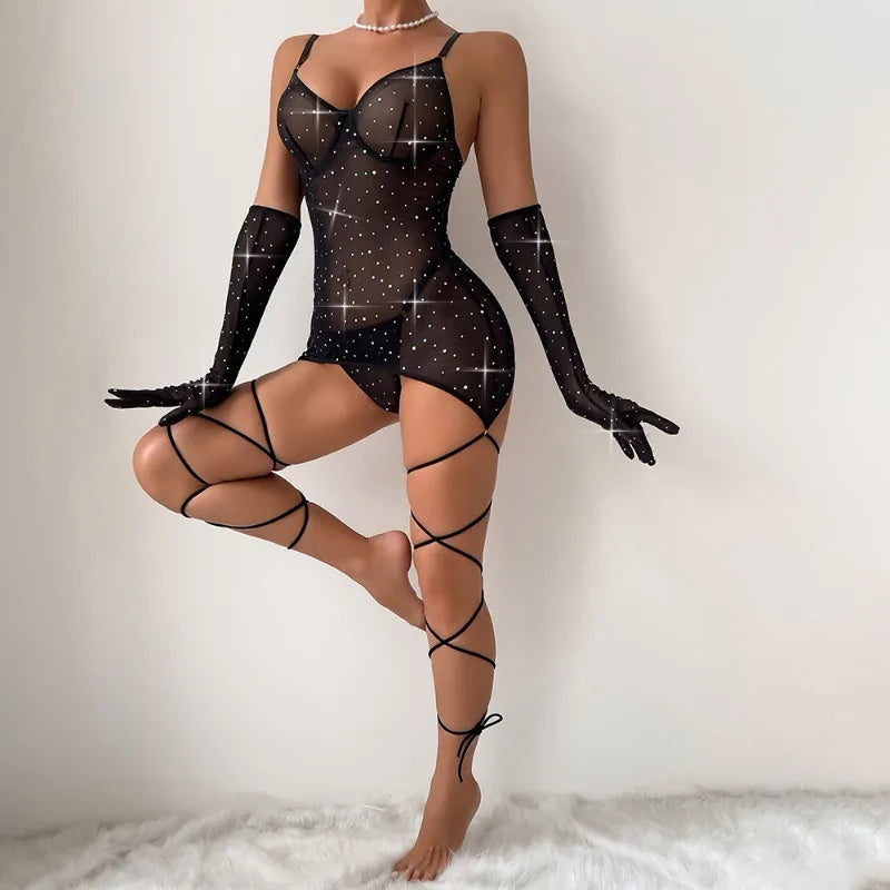 Person wearing a black mesh lingerie set with sparkling accents on a white background