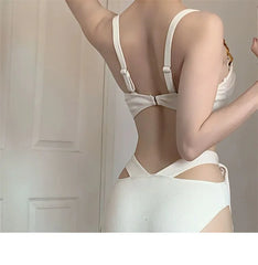 White lingerie set with cut-out design on a neutral background